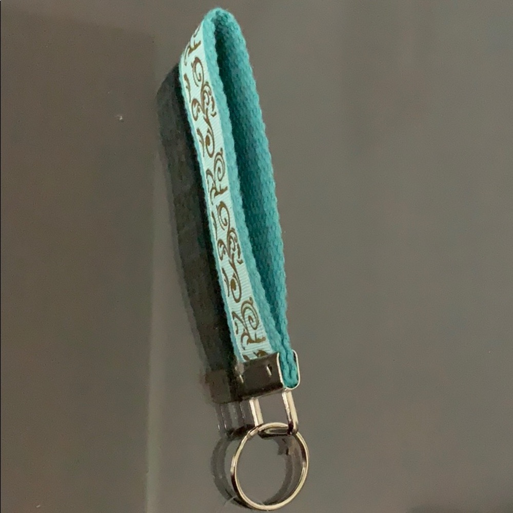 Wristlet With Gold Tone Design.